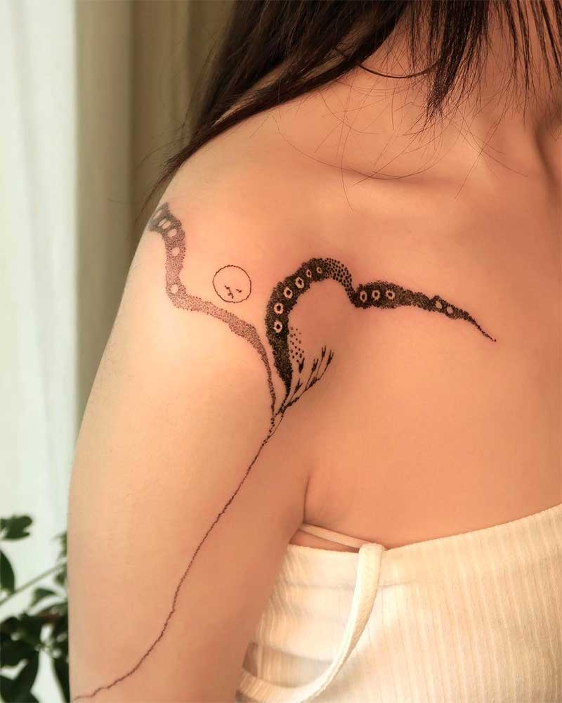 一个年轻的女人,一条蛇的肩膀纹身